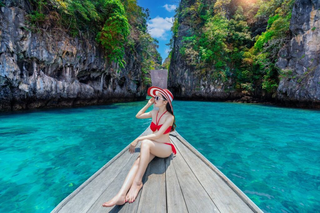Beautiful girl red bikini on boat Phi Phi Island