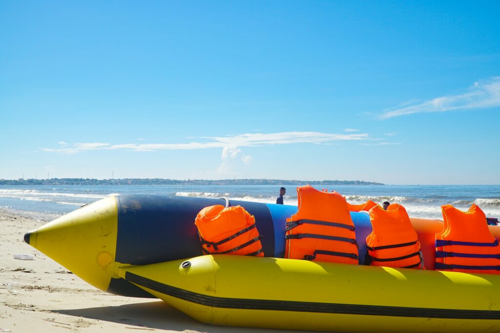 a banana boat resting on a sandy beach near the shoreline