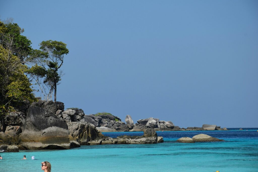 Similan Islands with turquoise water and some visitors chilling inside the water