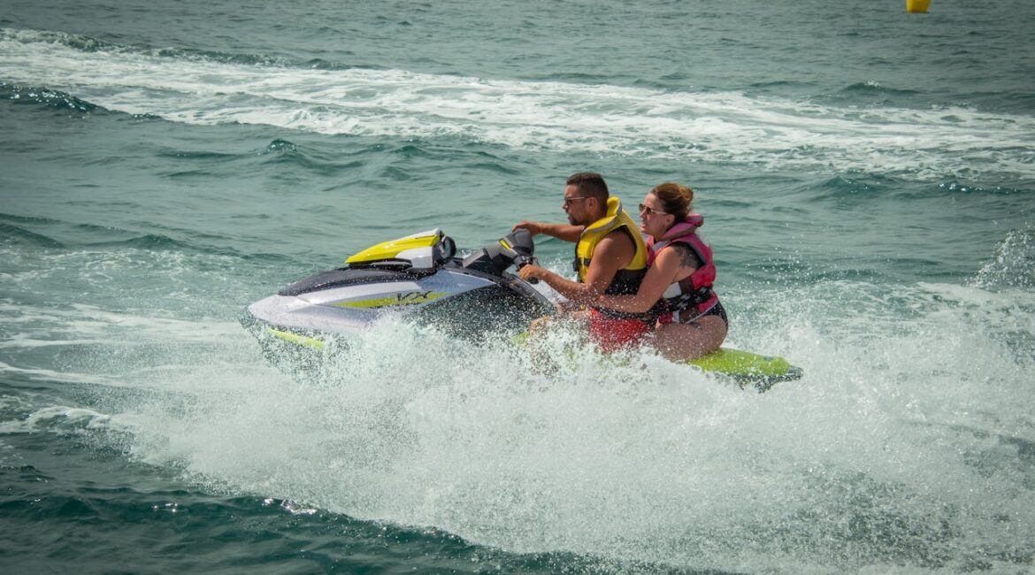 a couple jet skiing in the ocean