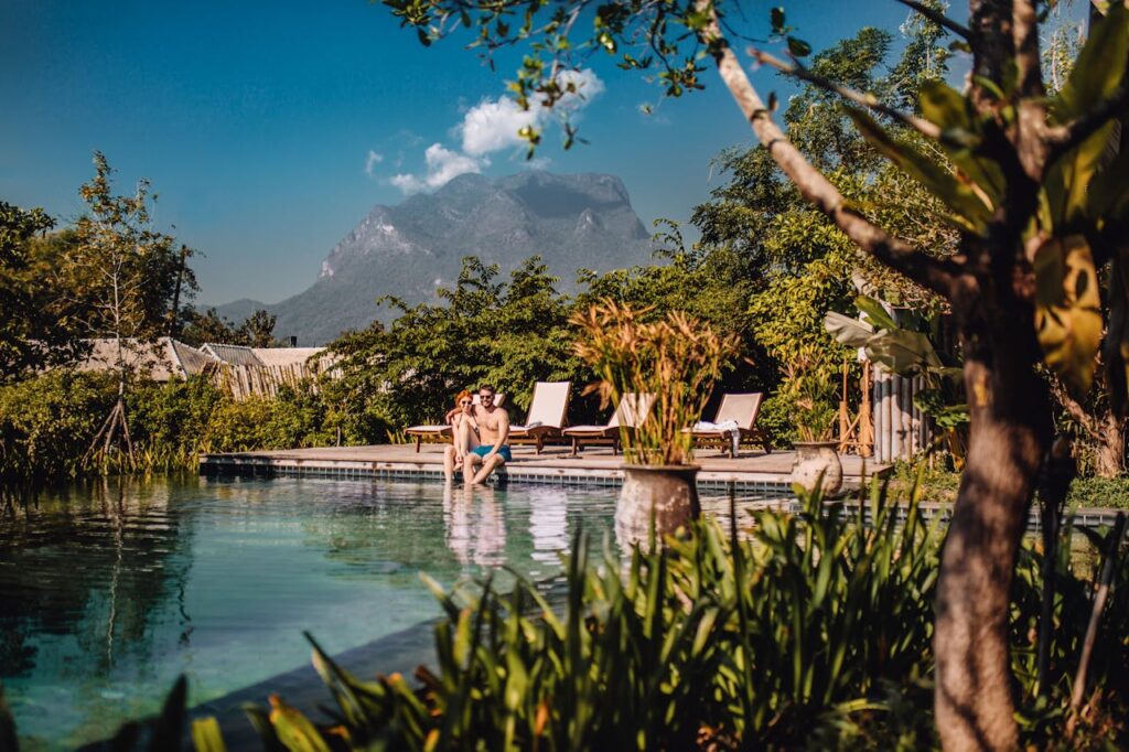 couples sitting beside the pool